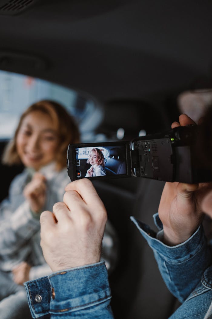 creative-02 A couple enjoys filming a candid moment together inside a car.